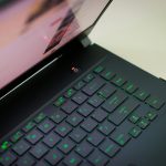 A sleek laptop with a glowing green keyboard illuminated, showcasing modern technology.